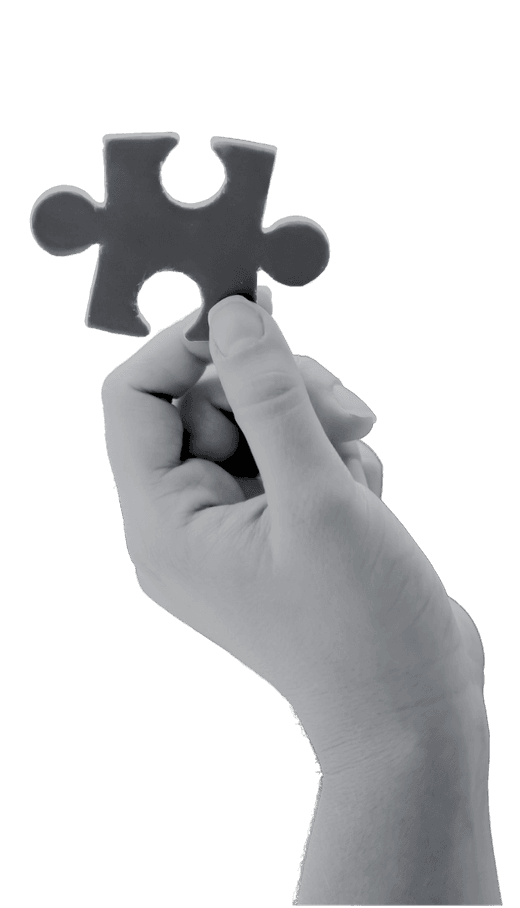 Hand holding a puzzle piece